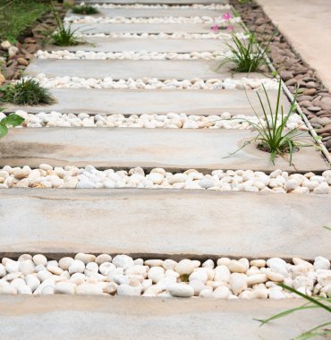 Landscaping modern simple stone pathway in garden decoration with white and brown pebbles clipart