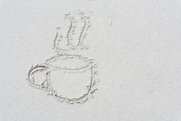 Drawn cup of coffee  on white sand beach background — Stock Photo, Image