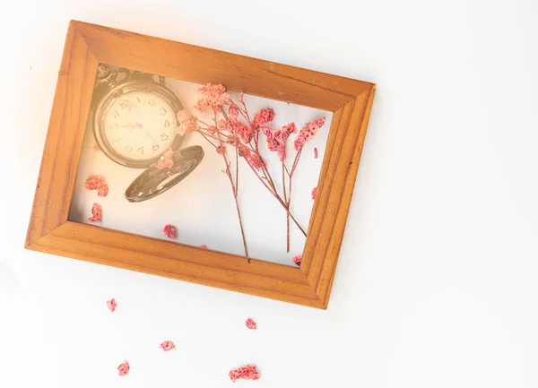 Beautiful pocket watch,pink dried flowers and wooden frame isola — Stock Photo, Image