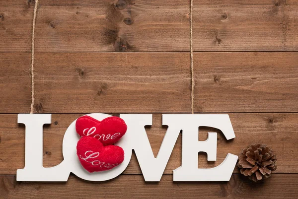 White love text hang with rope  and pine cone  on wooden backgro — Stock Photo, Image