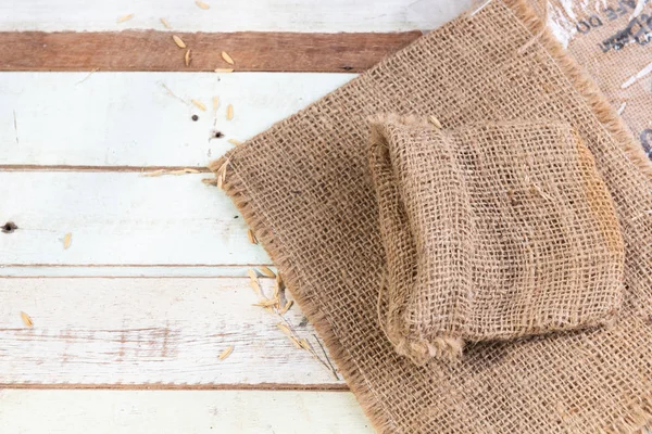 Burlap or sackcloth on wood table., top view — Photo