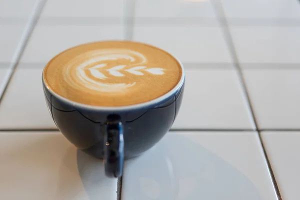 Latte art coffee cup on white table — Stock Photo, Image