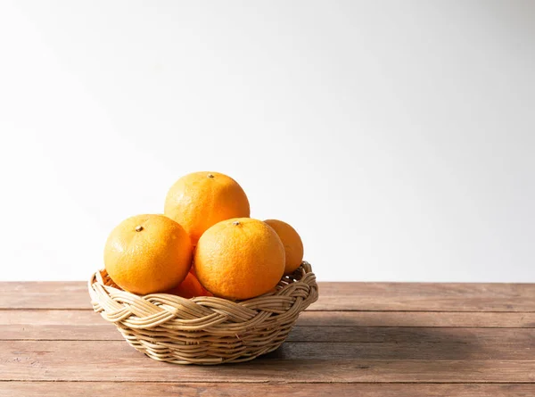 Fresh orange  fruits  set in bamboo tray on wood table with whit — Stock Photo, Image