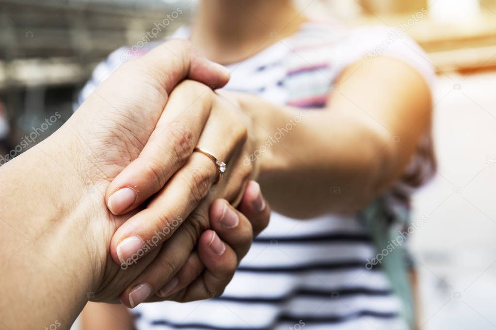 Beautiful women handshake with boyfriend close up.