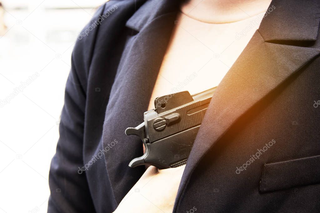 Close up women holding gun.