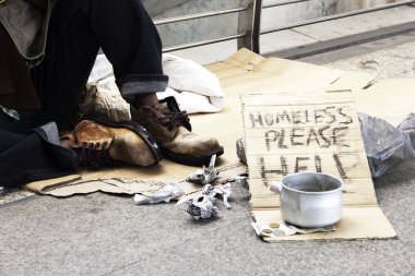 homeless man donation on street in the capital city.  clipart