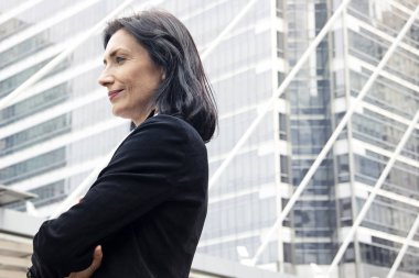 Gülümseyen ve ofisler arka, mavi renk şekil bina arıyorum güzel iş kadını.