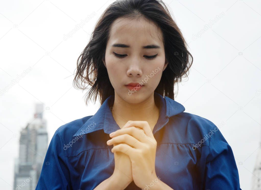 Beautiful Asia women portrait are praying and blessing on walking street.