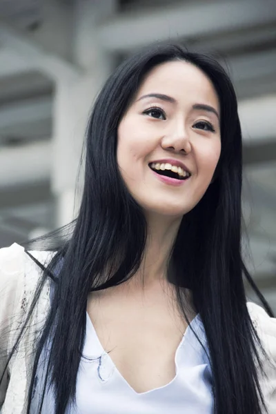 Beautiful business Asia women smile portrait and offices building background.