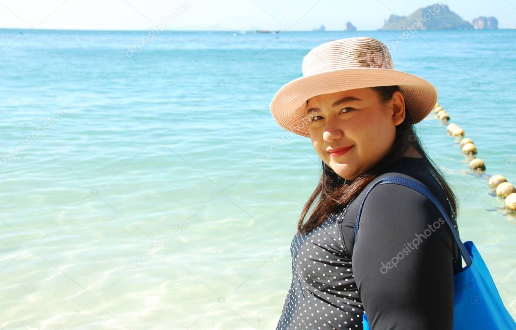 Beautiful Asia woman traveling beach in Thailand on summer holiday.