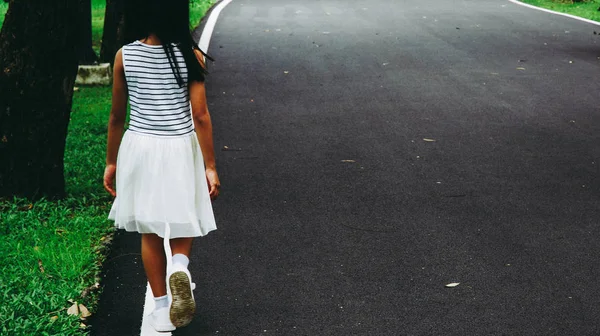 Beautiful asia girl walking in the public park in holiday weekend.