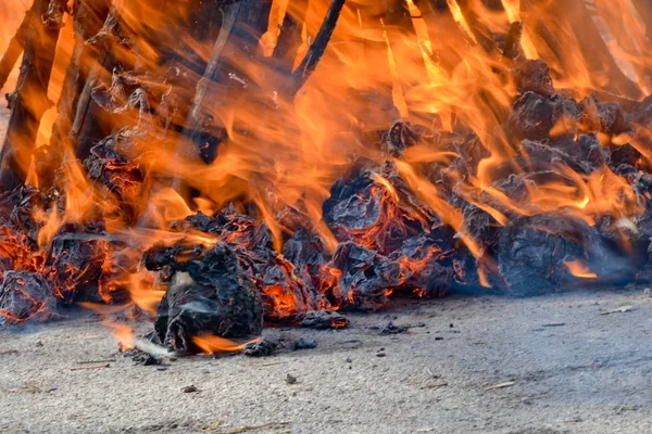 Slavic holiday end of winter. A large terry doll of straw is burning. Black smoke is visible