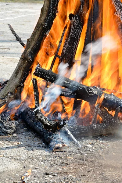 Slavic holiday end of winter. A large terry doll of straw is burning. Black smoke is visible