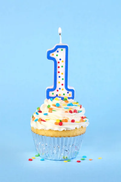 Iced birthday cupcake with with lit number 1 candle and sprinkle — Stock Photo, Image