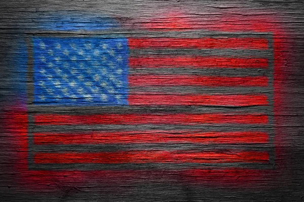 American flag spray painted on old distressed wood