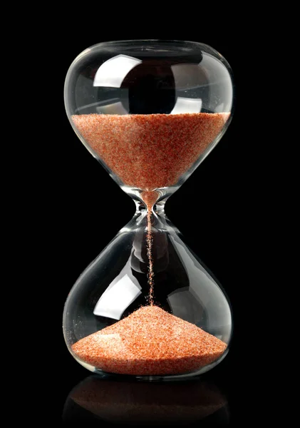 Hourglass with red sand showing the passage of time — Stock Photo, Image