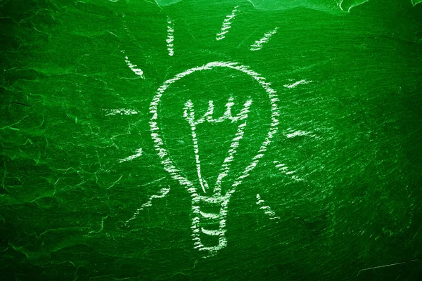 Light bulb on chalkboard — Stock Photo, Image