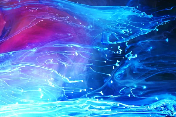 Blue and purple paints and inks swirling together in water abstr — Stock Photo, Image