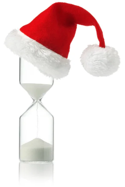 Hourglass med Christmas Santa hatt visar tidens gång — Stockfoto