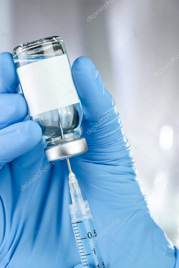Healthcare concept with a hand in blue medical gloves holding a 