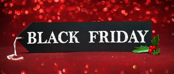 Black Friday sale tag on red glitter background — Stock Photo, Image