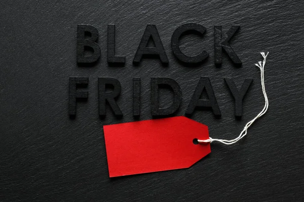 Black Friday text with red sale tag on slate background — Stock Photo, Image