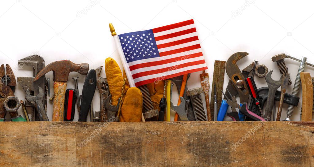 Patriotic collection of worn and used work tools with small US American flag. Made in USA, American workforce, or Labor Day concept.