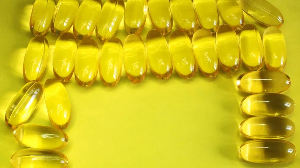 Vitamins yellow fish oil oval, healthy fish oil on a bright background free space for records