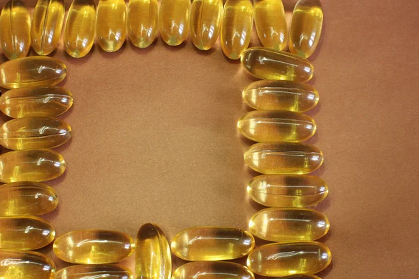 Vitaminler Sarı Balık Yağı Oval Kayıtları Için Parlak Bir Arka — Stok fotoğraf