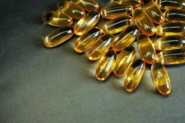 Vitamins yellow fish oil oval, healthy fish oil on a bright background free space for records