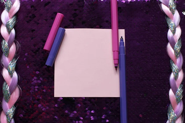 ピンクのノート紙とピンクと紫のフェルトペンのピンクのシートは スパンコールが輝き きらめきと光沢のある糸のピグテール レコードのための空きスペースと暗いピンクの背景ファブリックに — ストック写真