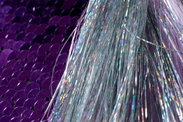 Brilliant silver threads shimmer on a background of sequins