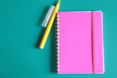 Sulu pembe not defteri ve parlak bir arka plan üzerinde notlar için alan