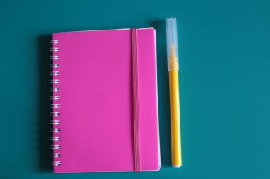 Sulu pembe not defteri ve parlak bir arka plan üzerinde notlar için alan