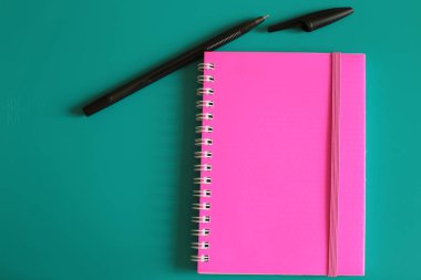 Sulu pembe not defteri ve parlak bir arka plan üzerinde notlar için alan