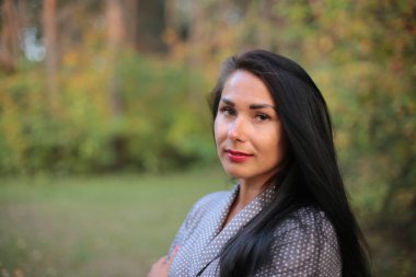 Parkta sonbaharda genç kadın ve siyah saçlı