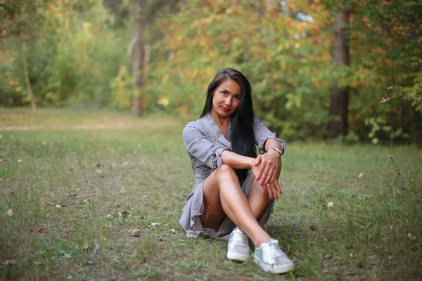 Young woman and black hair in autumn in the park