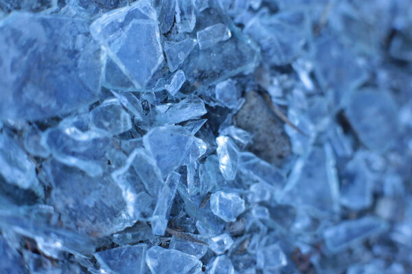 Background pieces of ice ilm small pieces of glass in tinted macro view