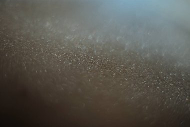 Arkaplan kumları kırılgan pullar, yanıp sönen parıldayan parıltılarla bokeh