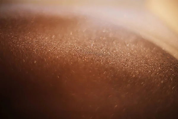 Arkaplan kumları kırılgan pullar, yanıp sönen parıldayan parıltılarla bokeh