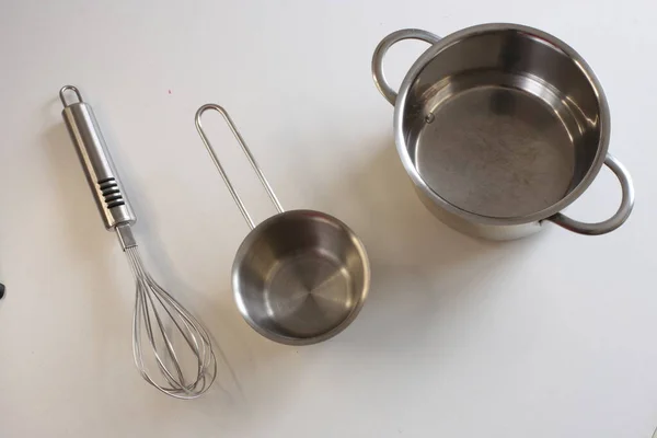 Empty kitchen utensils on white background