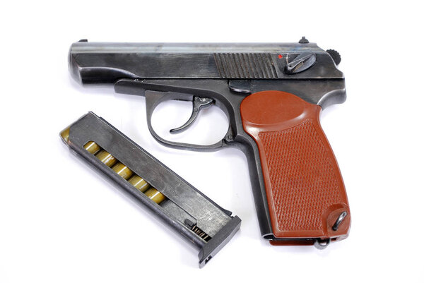 The traumatic gun with the loaded shop (holder) lies on a white background. Firearms of limited defeat and the loaded shop (holder) lying a row are isolated.