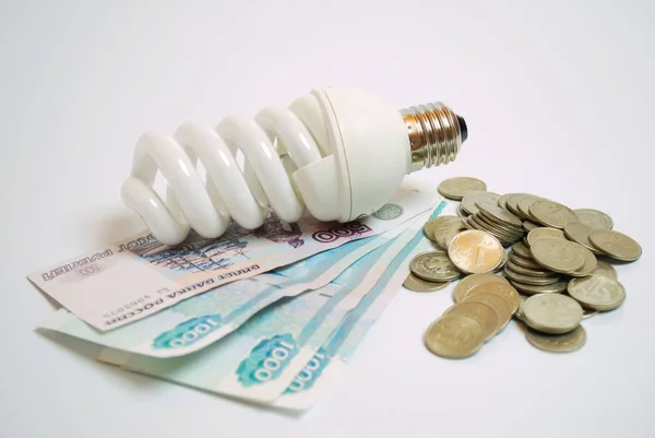 Energy-saving light bulb and money. Saving