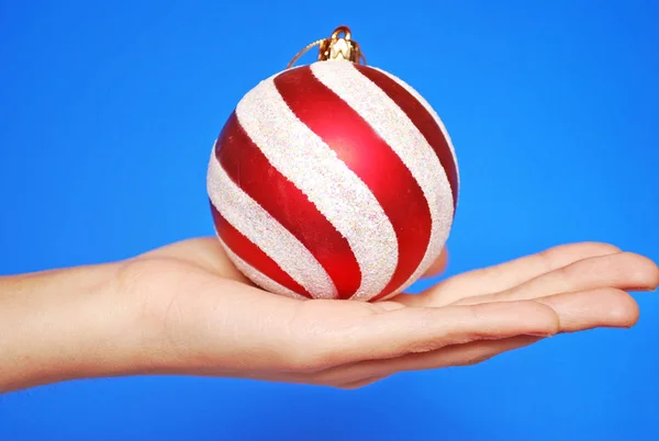 Christmas Toy Decoration Hand Blue Background Close — Stock Photo, Image