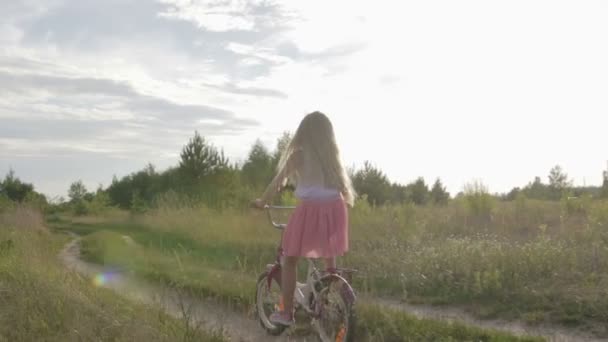 Linda menina, monta uma bicicleta infantil, crianças bicicleta — Vídeo de Stock