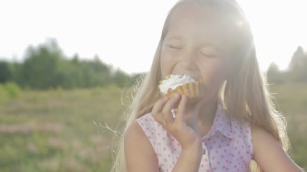 Beautiful, little girl eating brownie — Stock Video