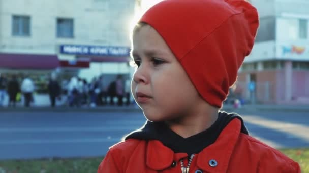Портрет мальчика, потерявшегося в городе и зовущего на помощь — стоковое видео