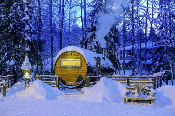 Building in form of barrel in winter forest