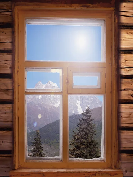 view through window on mountains with snow covered peaks