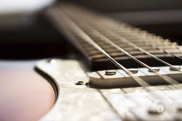 Pickups and electric guitar strings closeup